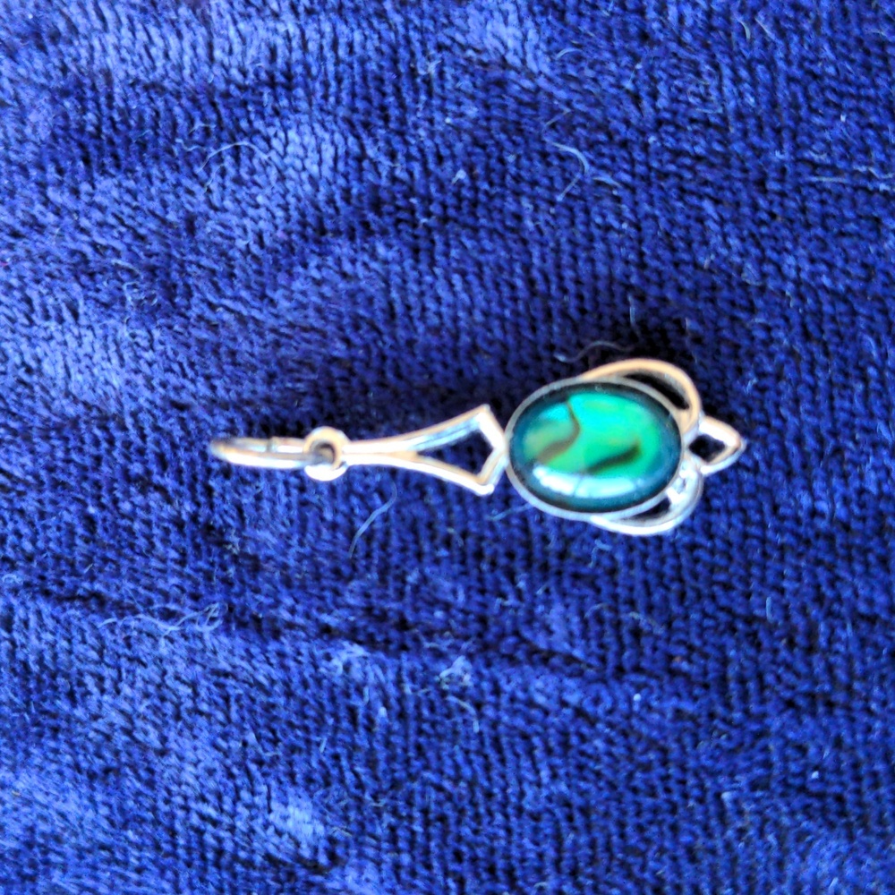 Vintage delicate silver tone pendant with glowing green insert